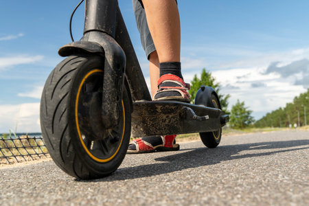 Rider enjoys the fresh air while using an electric scooter outdoors.
