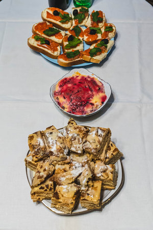 Delicious assortment of treats arranged on a white tablecloth, creating a tempting culinary display for a celebration or special occasionの写真素材