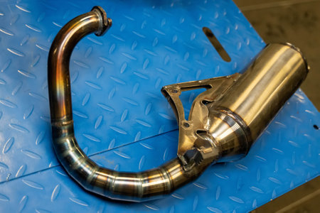 Close-up of a motorcycle exhaust system showcasing its metallic construction and intricate designの写真素材