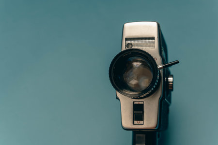 A classic film camera positioned against a blue backdrop.の写真素材