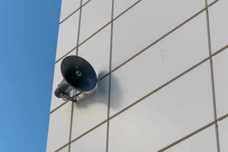 Loudspeaker announcing on white building with blue sky backgroundの写真素材