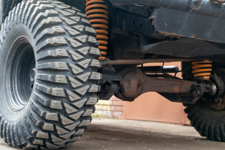 Close-up of off-road vehicles suspension system and mud terrain tiresの写真素材