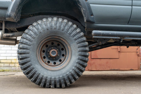 Close-up of big mud terrain tire on customized off-road vehicleの写真素材