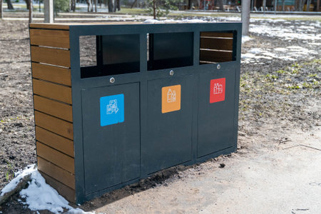 Modern recycling bins promoting waste sorting in public parkの写真素材