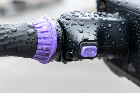 Electric scooter handlebar with rain drops showing turn signal switchの写真素材