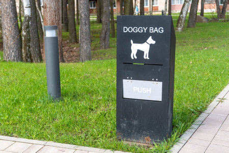Doggy bag dispenser providing waste bags for responsible pet owners in parkの写真素材