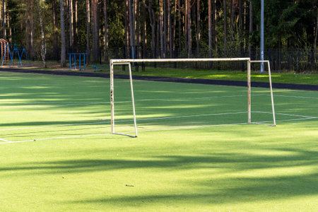 Empty soccer field with goal post on sunny dayの写真素材