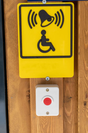 Accessibility button and sign for people with disabilities on wooden wallの写真素材