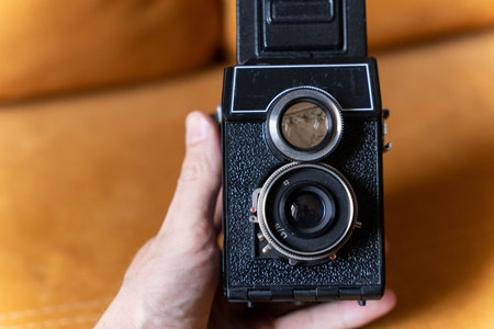 Photographer holding vintage twin lens reflex camera