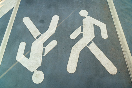 Pedestrian crossing sign showing two people walking in opposite directions