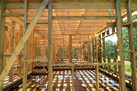 Wooden frame of a new house under construction reflecting on wet concrete floor