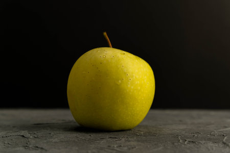 Fresh green apple with water droplets on grey backgroundの写真素材