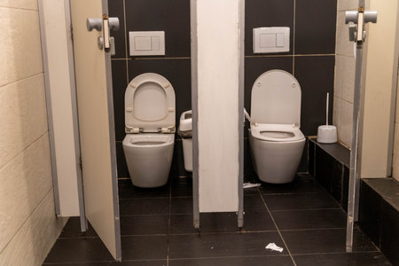 Public toilet stalls showing poor hygiene and lack of cleanliness