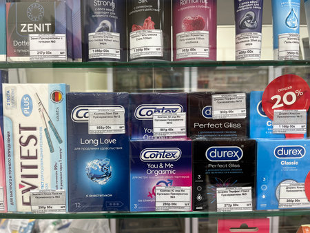Russia, Sosnovy Bor, October 12, 2025 -Shoppers choose from various condom brands in a local storeのeditorial素材
