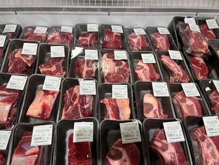 Russia, Sosnovy Bor, October 12, 2025 -Fresh meat cuts are neatly arranged in packages in a coolerのeditorial素材
