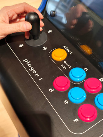Russia, St. Petersburg, March 14, 2026 -Person uses joystick and buttons on an arcade game machine...