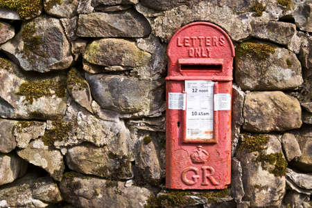 Welsh letterbox inlaid into a stone wall.の写真素材