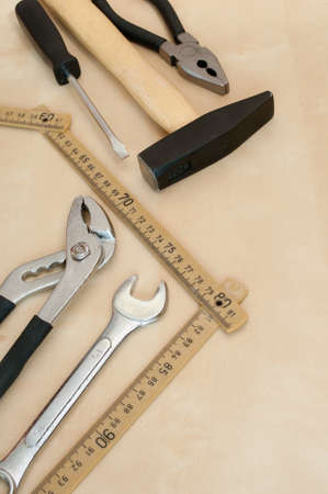 Set of Tools(Hammer, Screwdriver, Pliers, Spanner, Folding Rule) on Wooden Background With Copyspaceの写真素材