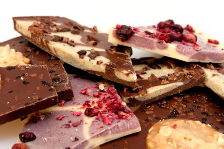 Different Kinds of Broken Chocolate Bars on White Background