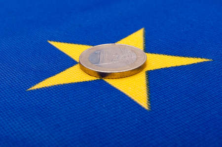 One Euro Coin on Blue Flag of European Unionの写真素材