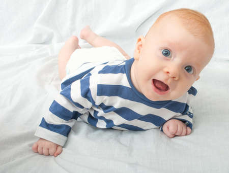 Closeup of Happy Smiling Newborn Baby Lying on Frontの写真素材