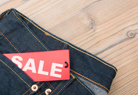 Red Sale Tag in Pocket of Blue Jeansの写真素材
