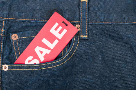 Red Sale Tag in Pocket of Blue Jeansの写真素材