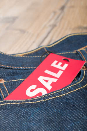 Red Sale Tag in Pocket of Blue Jeansの写真素材