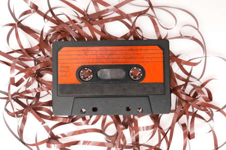 Retro Audio Cassette Tape With Pulled Out Tape on White Backgroundの写真素材