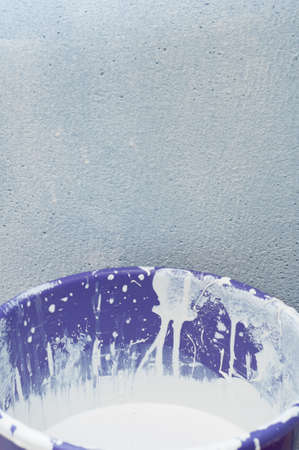 Background - House Improvement: Bucket Full of White Paint in Front of Wallの写真素材