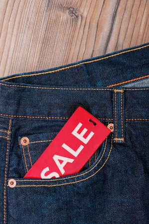 Red Sale Tag With Sale Sign in Pocket of Blue Jeans  - With Copyspaceの写真素材