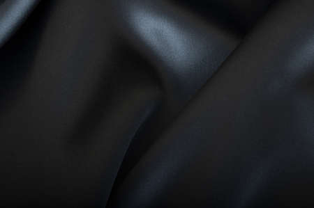 Black Texture - Closeup of Dark Wavy Glossy Silk Drapery の写真素材