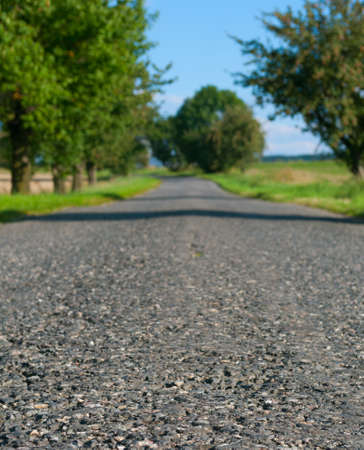 Country Asphalt Road - Shallow Depth of Filed. Focus on Front Part of Road.の写真素材