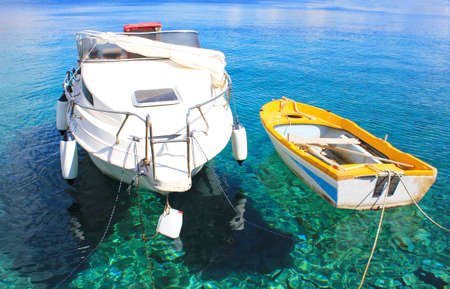 Two fishing boats in Emerald Azure Rippled Sea Water Bayの写真素材