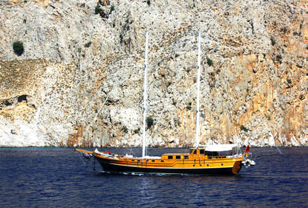 Yacht on the background of a cliff in the seaの写真素材