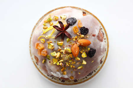 Delicious dessert pie with slices of dried fruit and almondsの写真素材