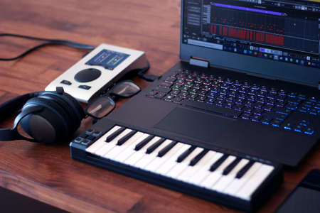 This is a picture of small and mobile mini music production studio that perfect for traveling and freelance! This is a great photo to highlight the topic of workplace mobility for a musician, composerの写真素材