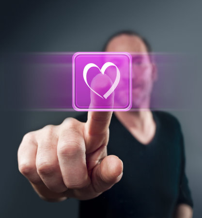Close-up of man touching heart shape icon