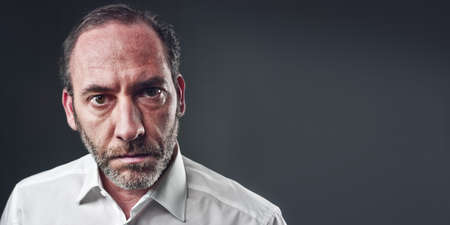 Portrait of a serious mature man isolated over colored background (shot on PhaseOne 45)の写真素材