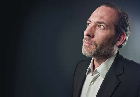 Portrait of a serious mature man isolated over colored background (shot on PhaseOne 45)の写真素材