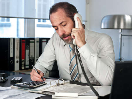 Mature businessman on the phone  Horizontal shotの写真素材