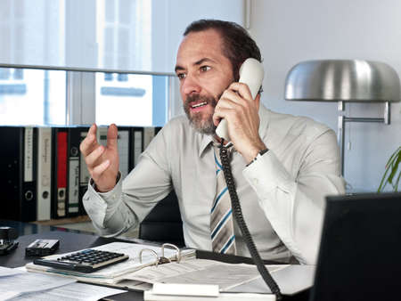 Mature businessman on the phone  Horizontal shotの写真素材