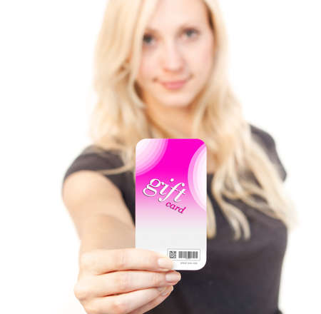 Young woman is smiling while showing her Gift Cardの写真素材