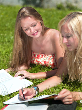 two girls are learning outside in the parkの写真素材