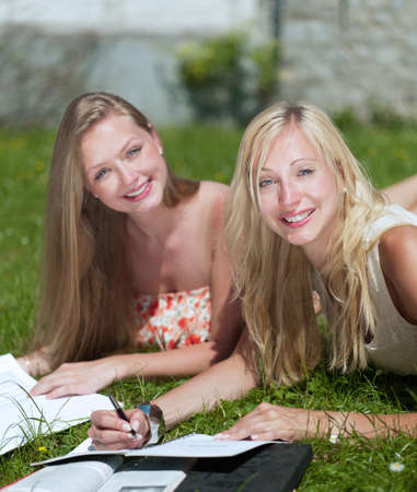 two girls are learning outside in the parkの写真素材