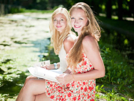 two girls are learning outside in the parkの写真素材