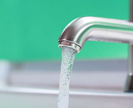 Running water out of modern faucetの写真素材