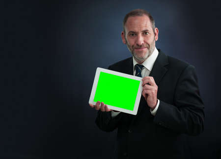 a mature businessman or salesman shows his pad - copy space for your contentの写真素材