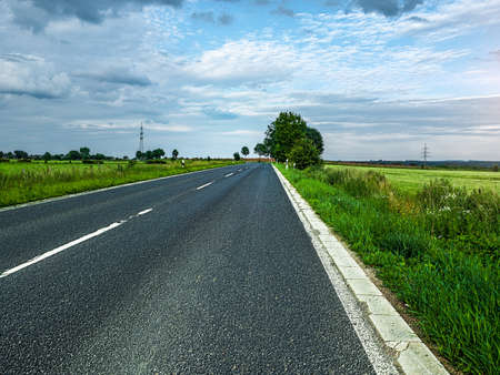 country road at sunset, cloudy backlite shot  peferct for car copy spaceの写真素材