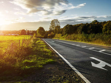 country road at sunset sundown, cloudy backlite shot  peferct for car copy spaceの写真素材